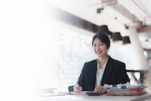 Portrait of an Asian businesswoman working with a happy smile in the office.