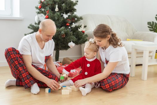 Toddler child with cochlear implant decorating christmas tree deafness and innovating medical technologies for hearing aid