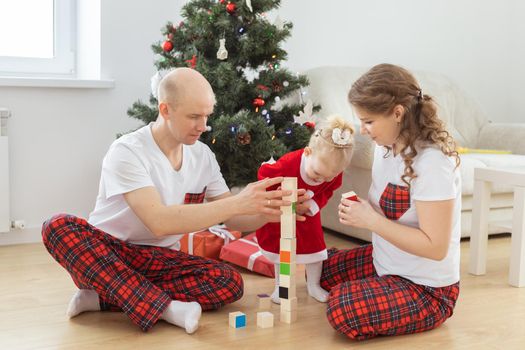 Toddler child with cochlear implant decorating christmas tree deafness and innovating medical technologies for hearing aid