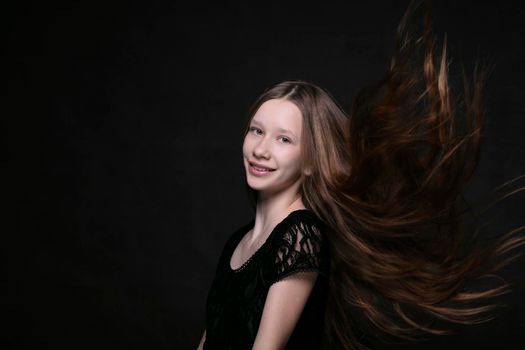 Portrait of a beautiful teenage girl with fluttering strands of hair.