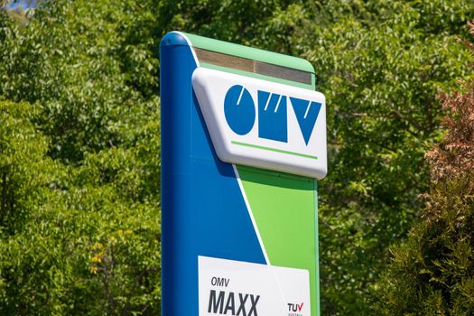 Lazarevac, Serbia - June 20, 2022: Logo and sign of OMV on gas station. OMV is a Hungarian-owned oil company operating in Serbia