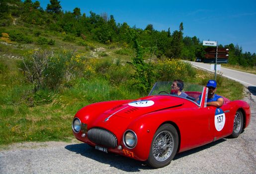 URBINO, ITALY - JUN 16 - 2022 : CISITALIA 202 S MM SPIDER NUVOLARI 1947 on an old racing car in rally Mille Miglia 2022 the famous italian historical race (1927-1957