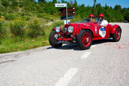 URBINO, ITALY - JUN 16 - 2022 : ASTON MARTIN 2 LITRE SPEED MODEL 1937 on an old racing car in rally Mille Miglia 2022 the famous italian historical race (1927-1957