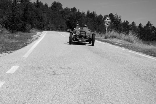 URBINO, ITALY - JUN 16 - 2022 : ASTON MARTIN 2 LITRE SPEED MODEL 1937 on an old racing car in rally Mille Miglia 2022 the famous italian historical race (1927-1957