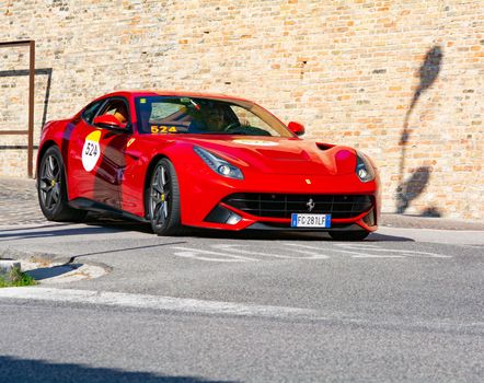 URBINO, ITALY - JUN 16 - 2022 : FERRARI TRIBUTE Ferrari F12 Berlinetta IN an old racing car in rally Mille Miglia 2022