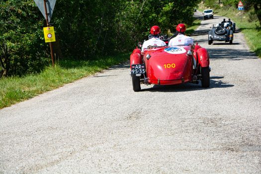 URBINO, ITALY - JUN 16 - 2022 : ASTON MARTIN 2 LITRE SPEED MODEL 1937 on an old racing car in rally Mille Miglia 2022 the famous italian historical race (1927-1957