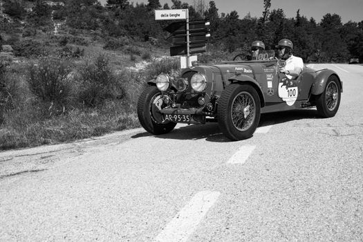 URBINO, ITALY - JUN 16 - 2022 : ASTON MARTIN 2 LITRE SPEED MODEL 1937 on an old racing car in rally Mille Miglia 2022 the famous italian historical race (1927-1957