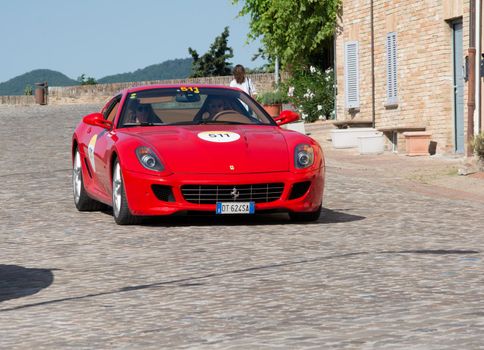 URBINO, ITALY - JUN 16 - 2022 : FERRARI TRIBUTE Ferrari 599 Gtb Fiorano IN an old racing car in rally Mille Miglia 2022