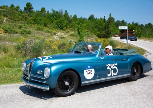 URBINO, ITALY - JUN 16 - 2022 : ALFA ROMEO 6C 2500 S CABRIOLET PININ FARINA 1947 on an old racing car in rally Mille Miglia 2022 the famous italian historical race (1927-1957