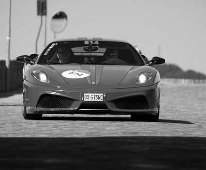 URBINO, ITALY - JUN 16 - 2022 : FERRARI TRIBUTE Ferrari F430 Scuderia IN an old racing car in rally Mille Miglia 2022