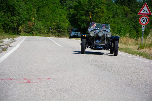 URBINO, ITALY - JUN 16 - 2022 : ALFA ROMEO 6C 1750 SUPER SPORT ZAGATO 1929 on an old racing car in rally Mille Miglia 2022 the famous italian historical race (1927-1957