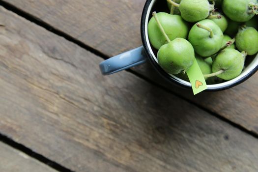 Food background. Healthy vegan food concept. Green apples in a cup.