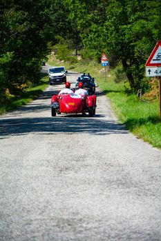 URBINO, ITALY - JUN 16 - 2022 : ASTON MARTIN 2 LITRE SPEED MODEL 1937 on an old racing car in rally Mille Miglia 2022 the famous italian historical race (1927-1957