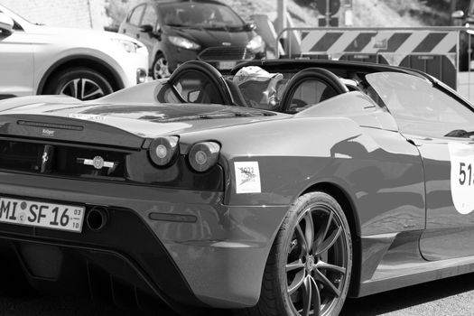 URBINO, ITALY - JUN 16 - 2022 : FERRARI TRIBUTE Ferrari F430 Scuderia Spider IN an old racing car in rally Mille Miglia 2022