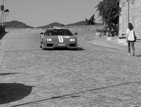 URBINO, ITALY - JUN 16 - 2022 : FERRARI TRIBUTE Ferrari MODENA IN an old racing car in rally Mille Miglia 2022