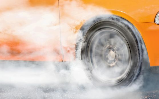 Drag racing car burns rubber off its tire in preparation for the race (front wheel drive)