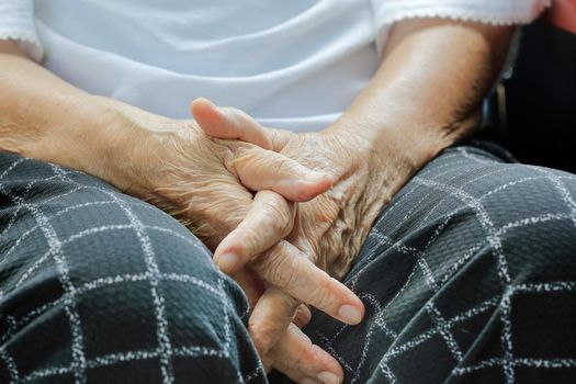 Elderly woman hand while waiting on wheelchair