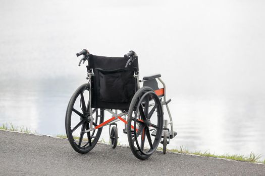 Empty wheelchair on lake