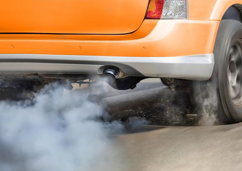 Air pollution from vehicle exhaust pipe on road