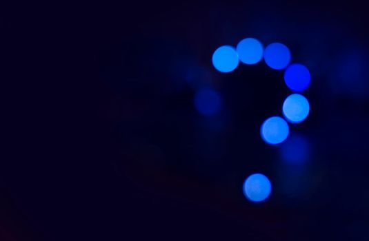 Question mark in blue abstract light background. Neon light night discussion.