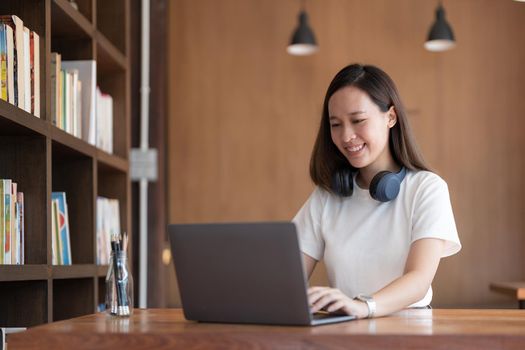 Portrait of Young Asian woman hand freelancer is working her job on laptop computer. Doing accounting analysis report real estate investment data, Financial and tax systems concept