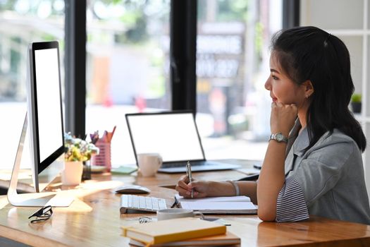 Side view thoughtful businesswoman reading financial at on computer screen.