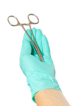 Woman's hand in a latex glove with stainless steel needle holder on the white isolated background.
