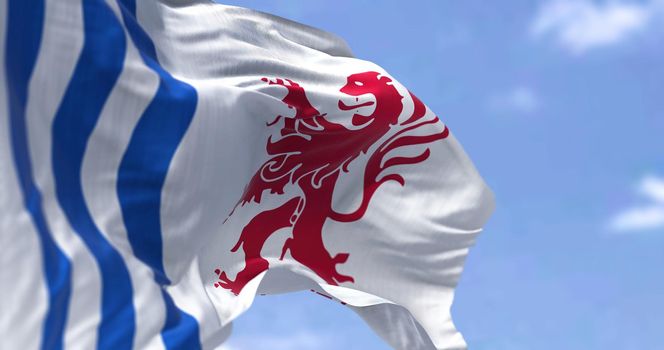 The flag of Nouvelle-Aquitaine waving in the wind on a clear day. Nouvelle-Aquitaine is the largest administrative region in France