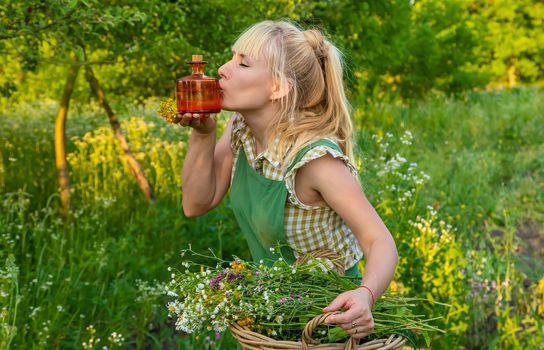 A woman makes herbal tincture. Selective focus. Nature.
