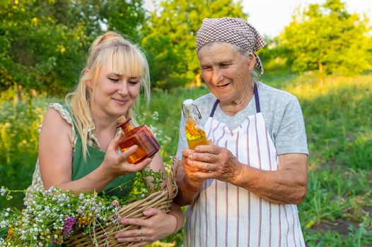 A woman makes herbal tincture. Selective focus. Nature.