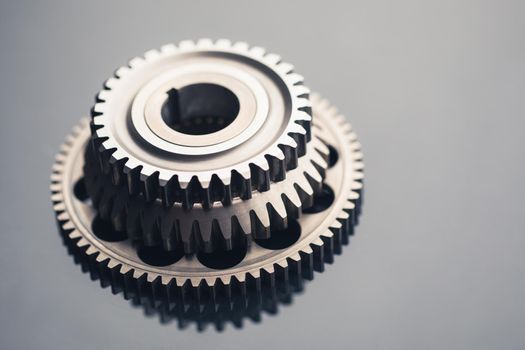 gear wheel steel on gray background, close-up view