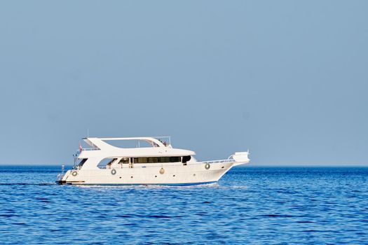 Floating white yacht against the blue sky. The concept of rest and travel.
