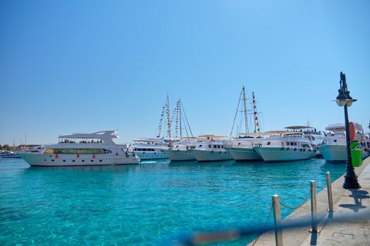 A bay with a large cluster of yachts at the pier.