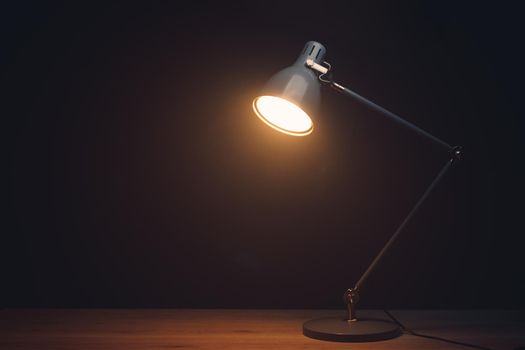 desk lamp in mist, black background with copy-space