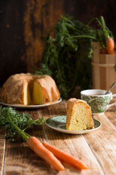 Sugar glazed carrot cake, homemade baked goods, rustic still life, national carrot cake day, cup of coffee. High quality photo