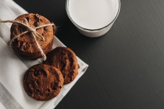 Flat Lay of Glass is Filled with Milk and Homemade Cookies on Black Table