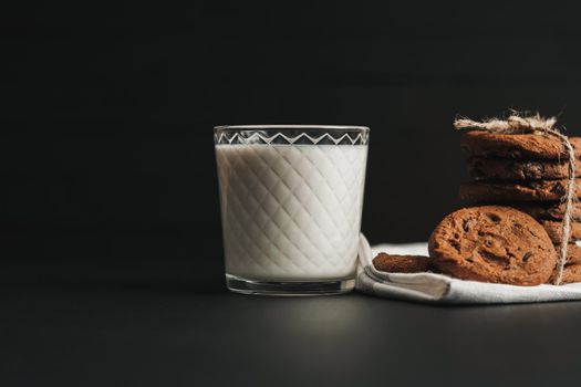 Glass is Filled with Milk and Homemade Cookies on Black Table