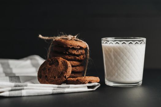 Glass is Filled with Milk and Homemade Cookies on Black Table