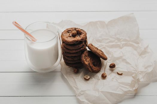 Homemade Cookies and Glass Filled with Milk on White Table