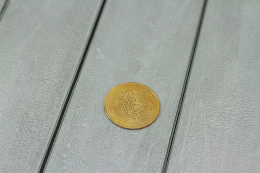 bitcoin gold coin on gray wooden background. Online payment technology, digital wallet, computer financial, digital blockchain, bitcoin stock, cryptocurrency trading and mining investment concept.