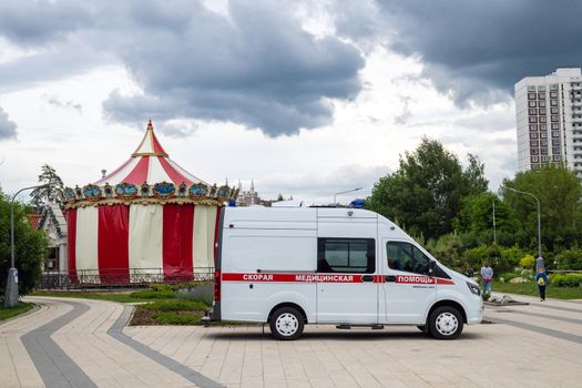 Moscow, Russia - June 17. 2022. An ambulance is on duty near children's entertainment center