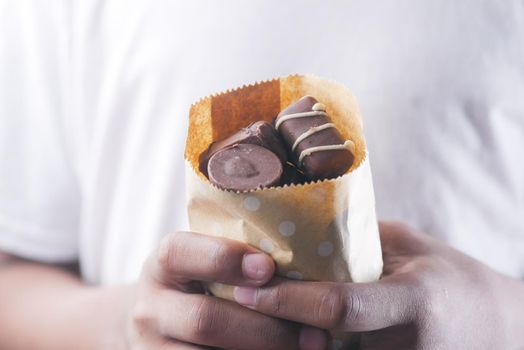 dark chocolate in a take away paper packet .