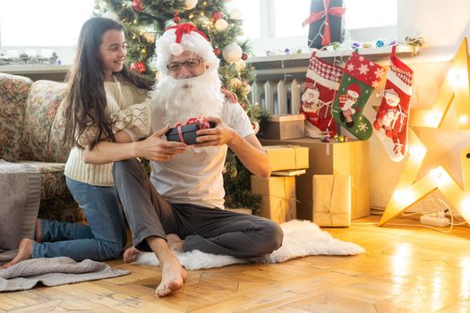 daughter and father in Santa Claus costume Christmas.