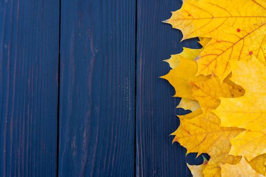 Autumn leaves frame on one right side wooden background top view Fall Border yellow and Orange Leaves vintage wood table Copy space. Mock up for your design. Display for product or text