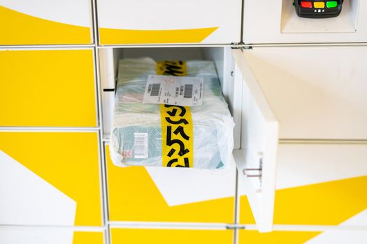 Moscow, Russia - June 17. 2022. Parcel from the delivery service Yandex Market in the cell postamat