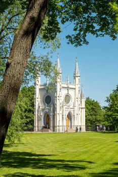 St. Petersburg, Peterhof, Russia - June 25, 2022. Beautiful building of the Gothic chapel in Alexandria park. Historical buildings, architecture. Selective focus.