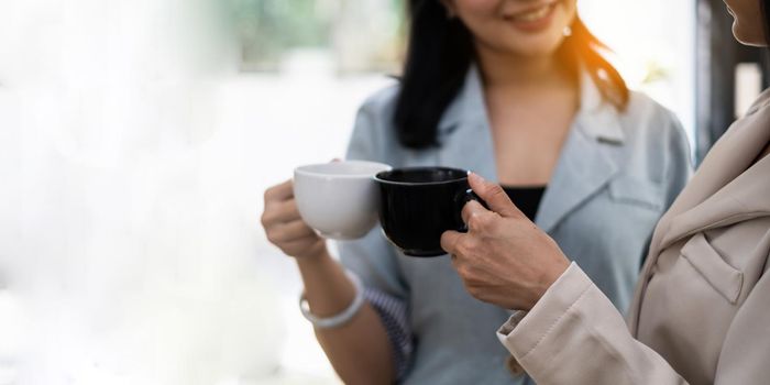 Two Young asian business woman have coffee break at office. finance and accountant Concept