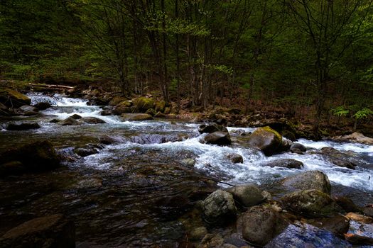 Beautiful autumn landscape of flowing cascade water in a mountain river
