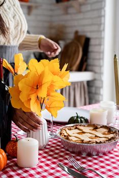 Happy Thanksgiving Day. Autumn feast. Woman celebrating holiday cooking traditional dinner at kitchen, decorating home