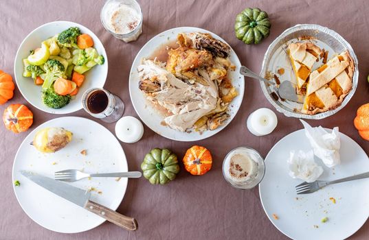 Happy Thanksgiving Day. Autumn feast. top view of thanksgiving table after feast, leftovers and dirty dishes. Cleaninf after feast